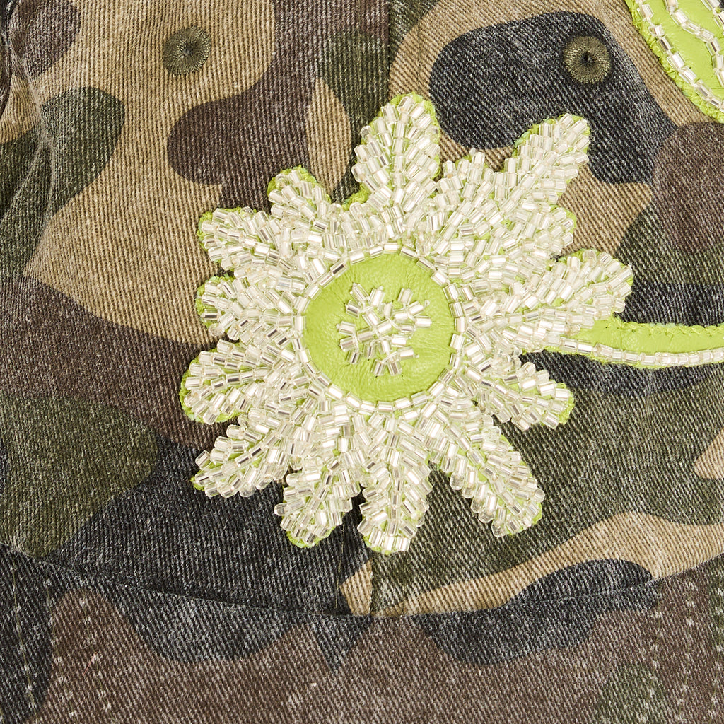 Zoom view of BLUEMARBLE washed cotton camouflage baseball cap featuring a hand-embroidered floral beaded leather patch on the front panel and an adjustable metal clasp at the back.