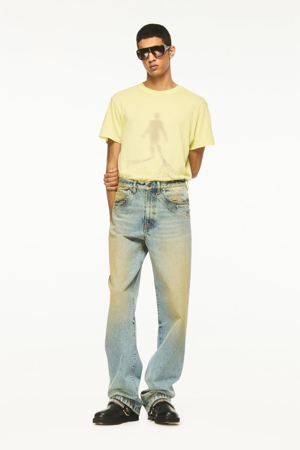 BLUEMARBLE sand-washed blue denim pants featuring a relaxed fit, curved panel detailing at the back, five-pocket construction and a leather logo patch at the back waistband.