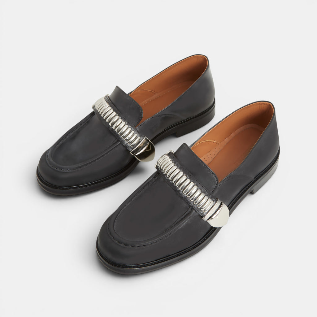 Men's black leather loafers with a silver buckle
